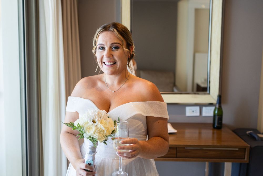 Bride smiling holding her flowers