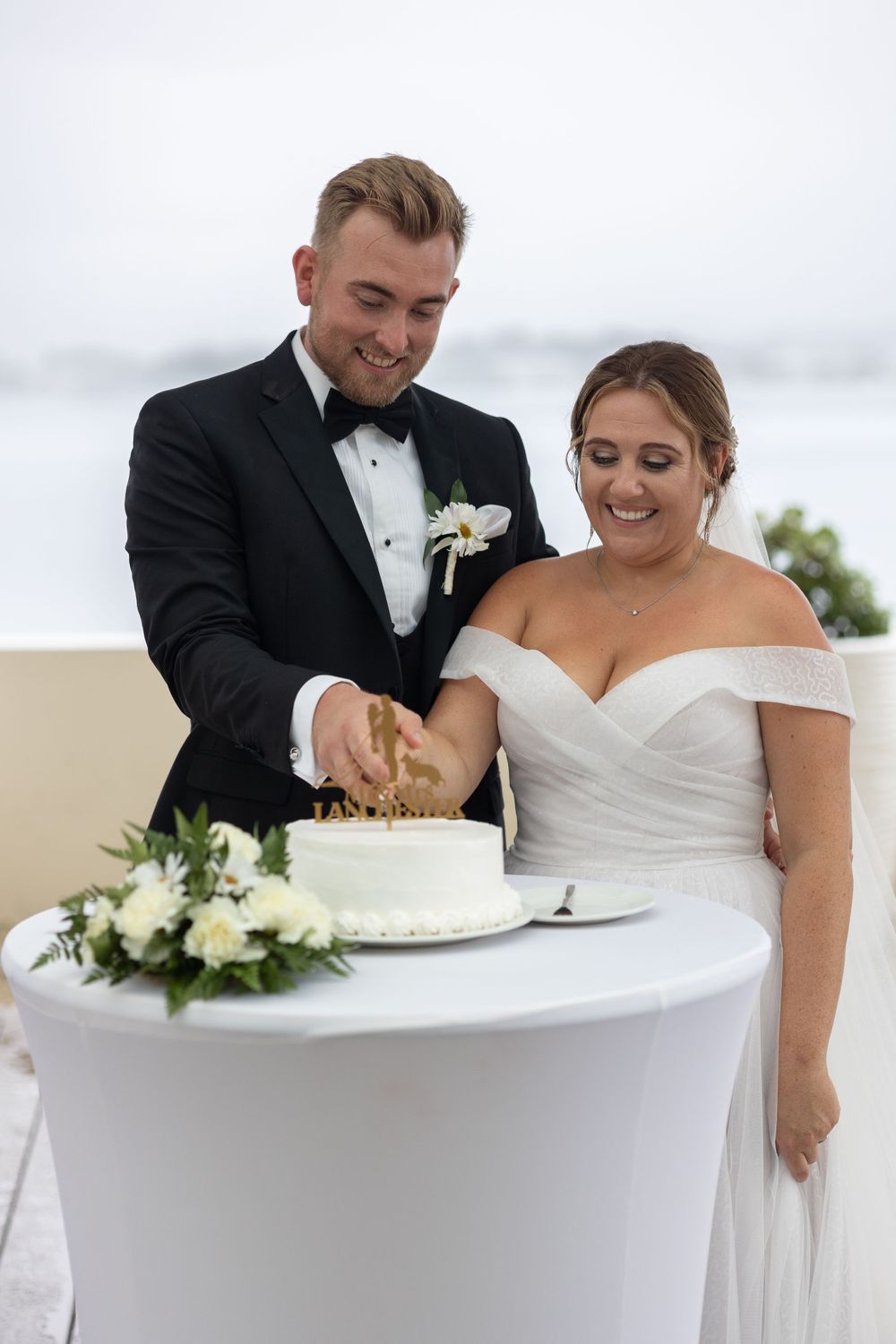 Bride and groom cutting wedding cake