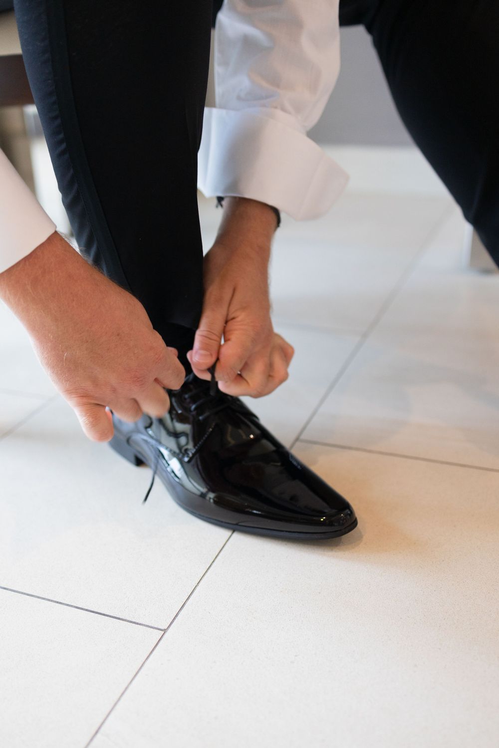 Groom putting shoes on