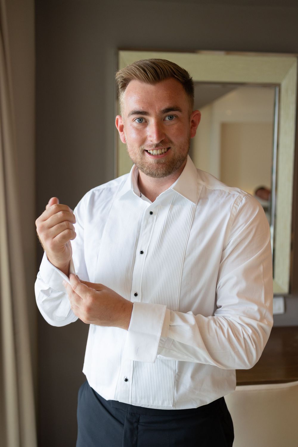 Groom adjusting cufflinks