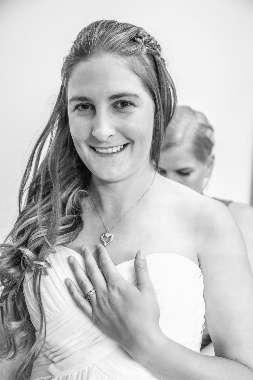 Black and white portrait of a person in a wedding dress with flowing hair.