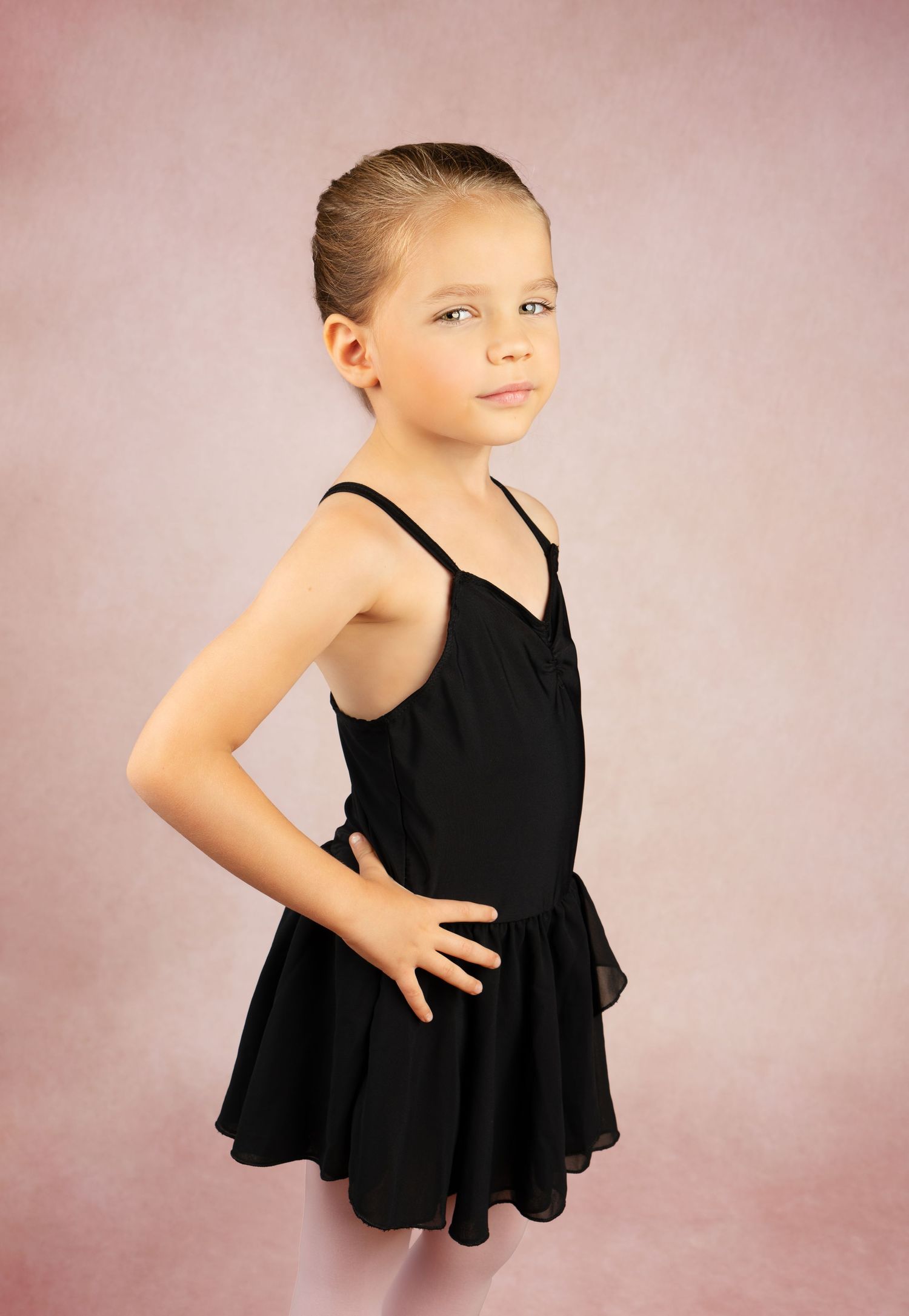 young girl poses in dance costume