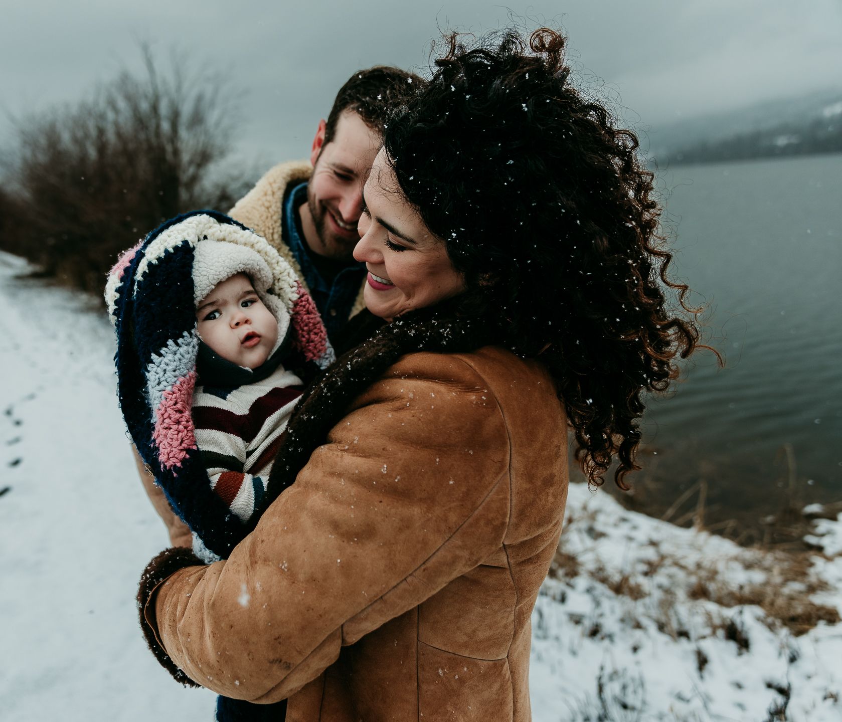 Family with baby at a frozen lake