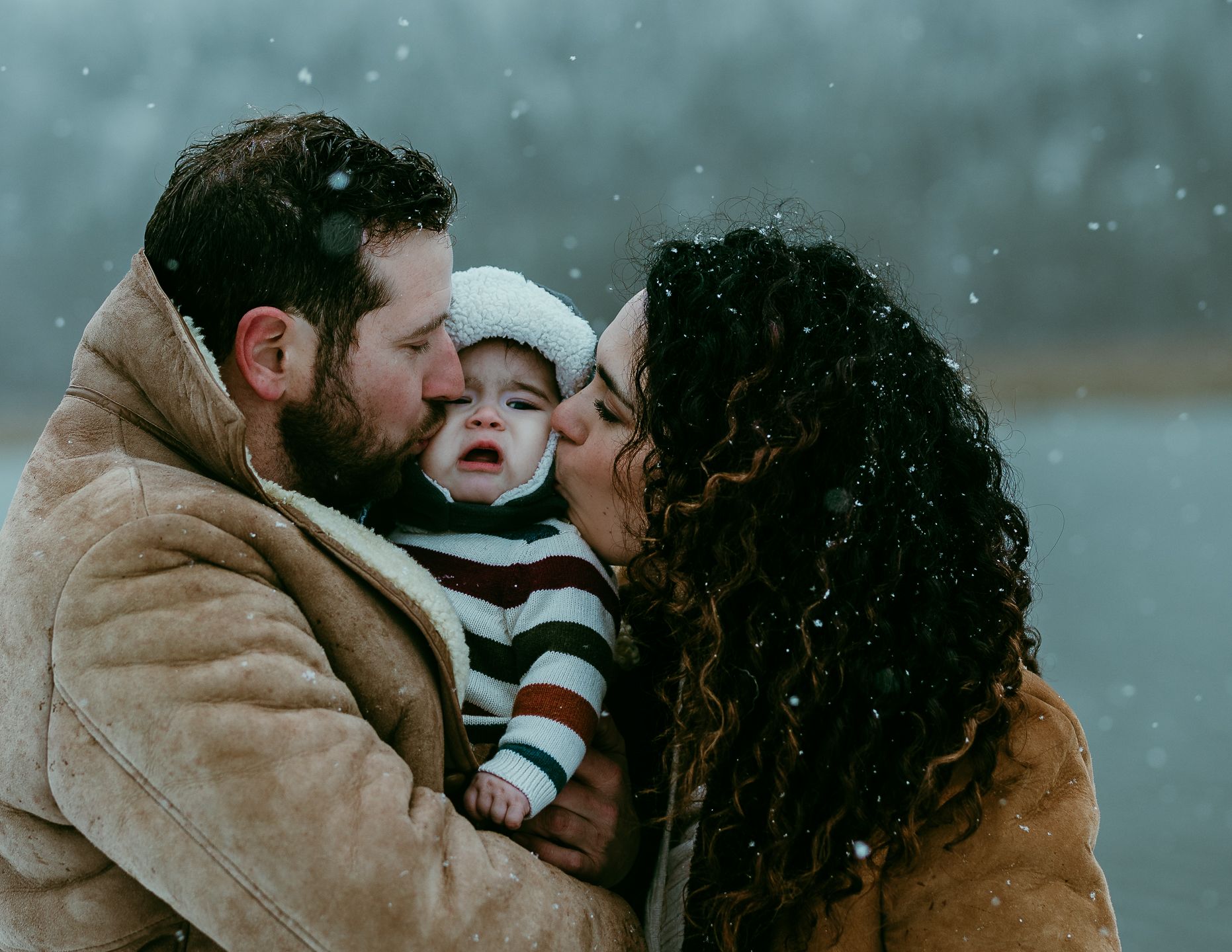 Mom dad and baby in winter
