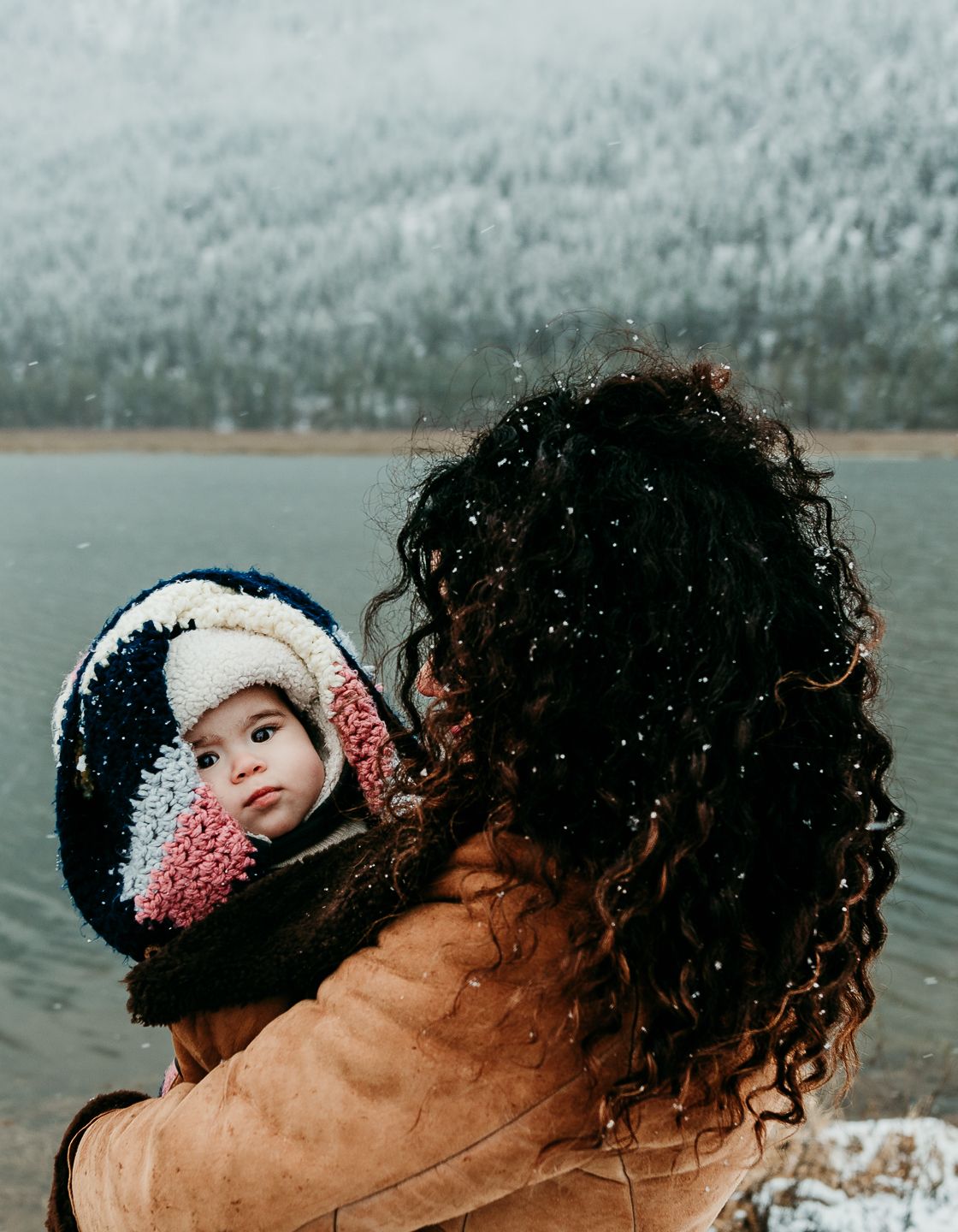 Mom and baby near a frosty lake