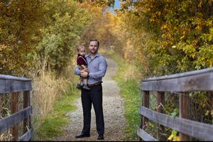 Dad holding his son on a nature walk