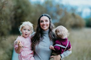 Amanda smiling as she holds her two children
