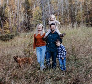 Family and their dog in a field