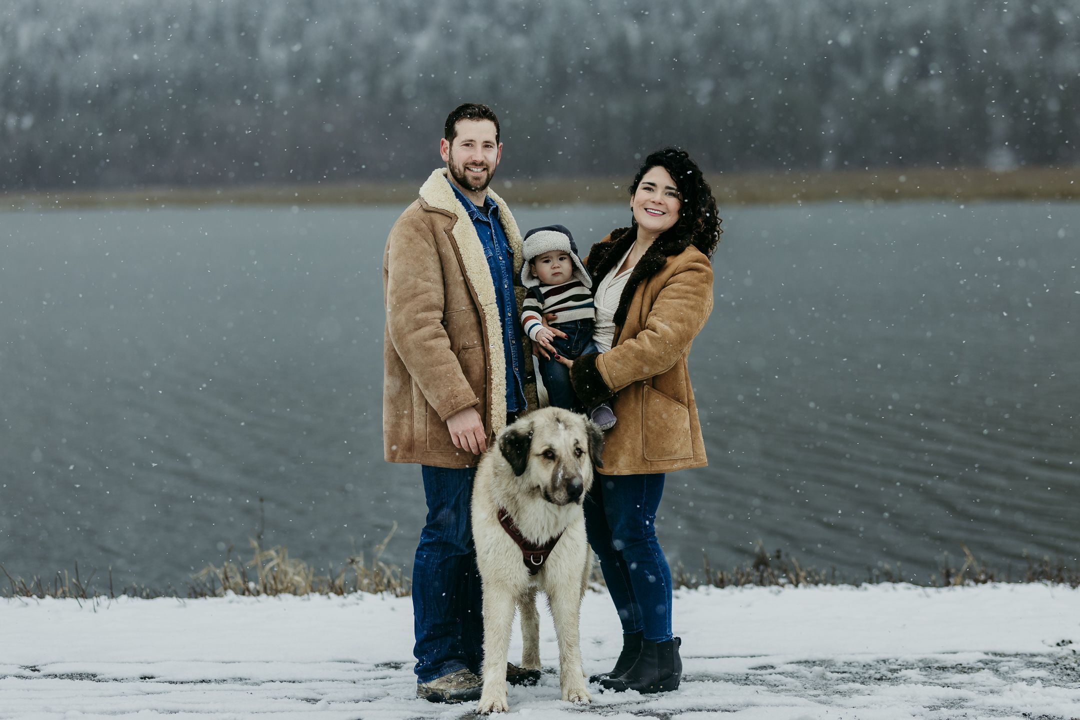 Family with their baby and dog in winter