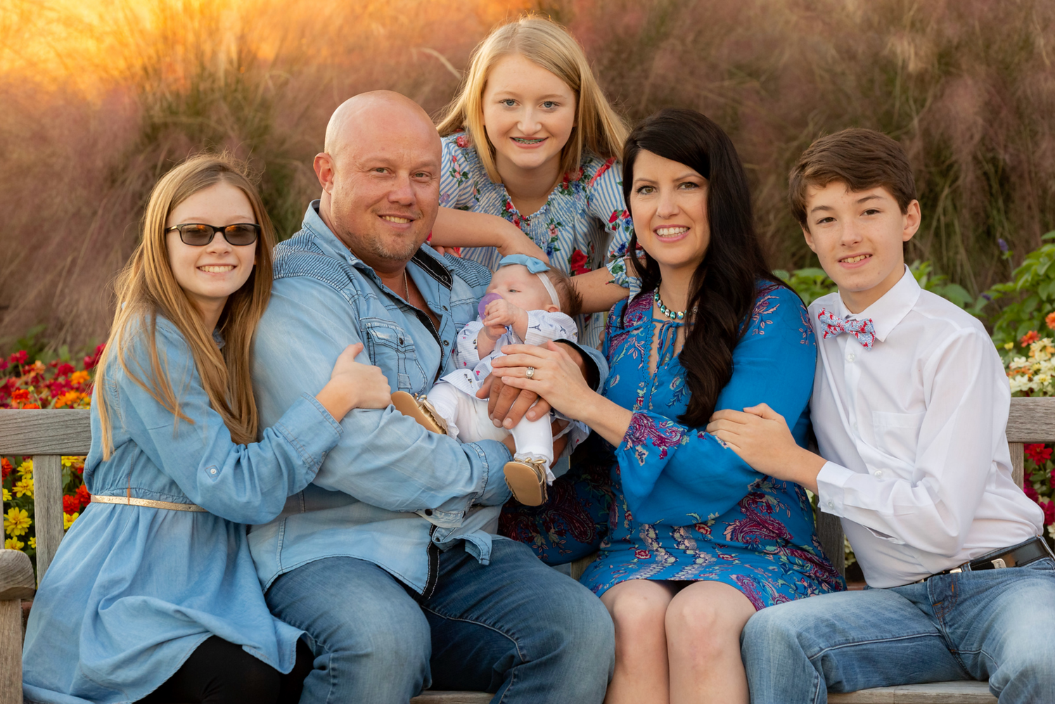 party of 6, family seated on bench, seagrass background