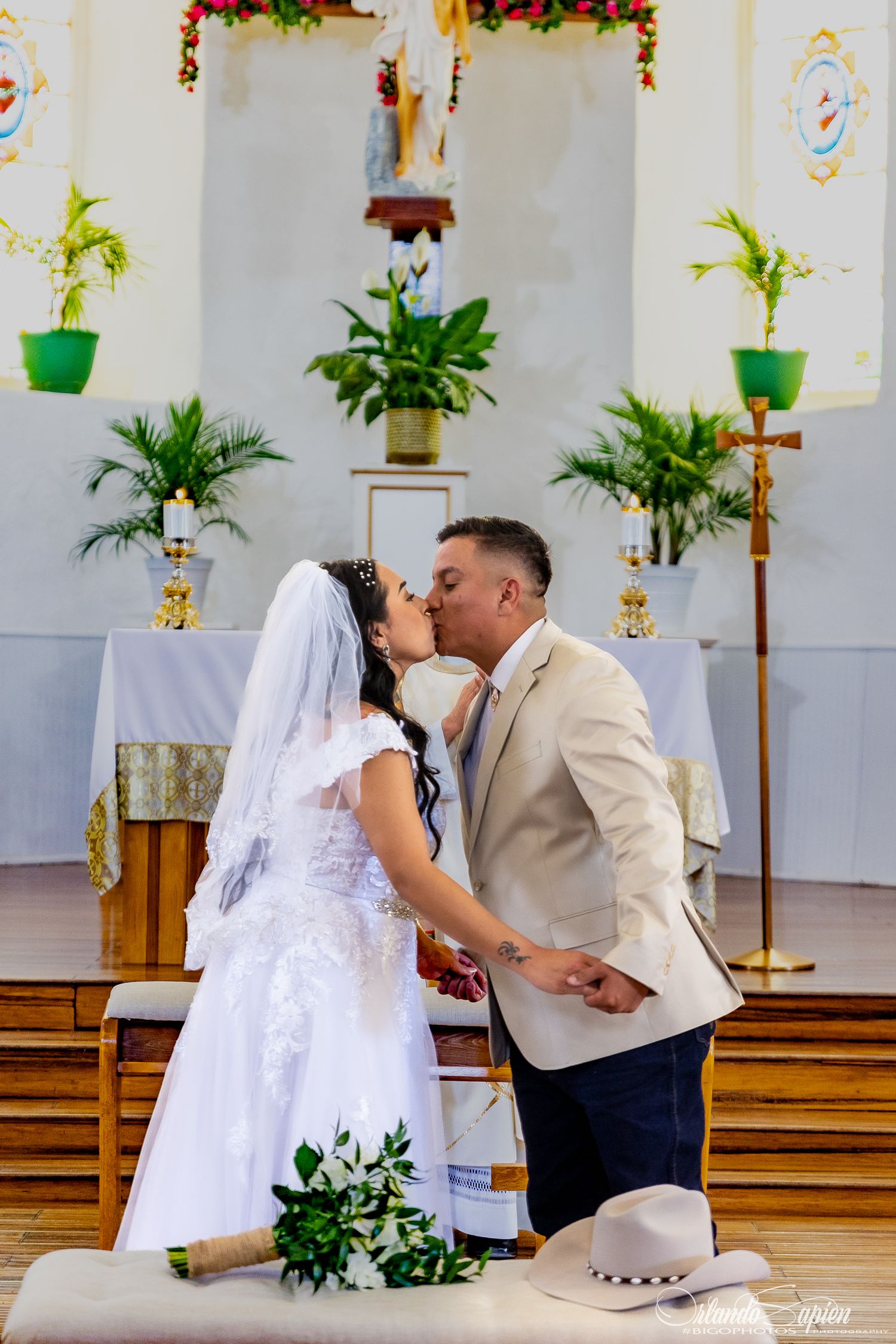 A wedding ceremony sequence inside a church decorated with plants and holiday garlands.