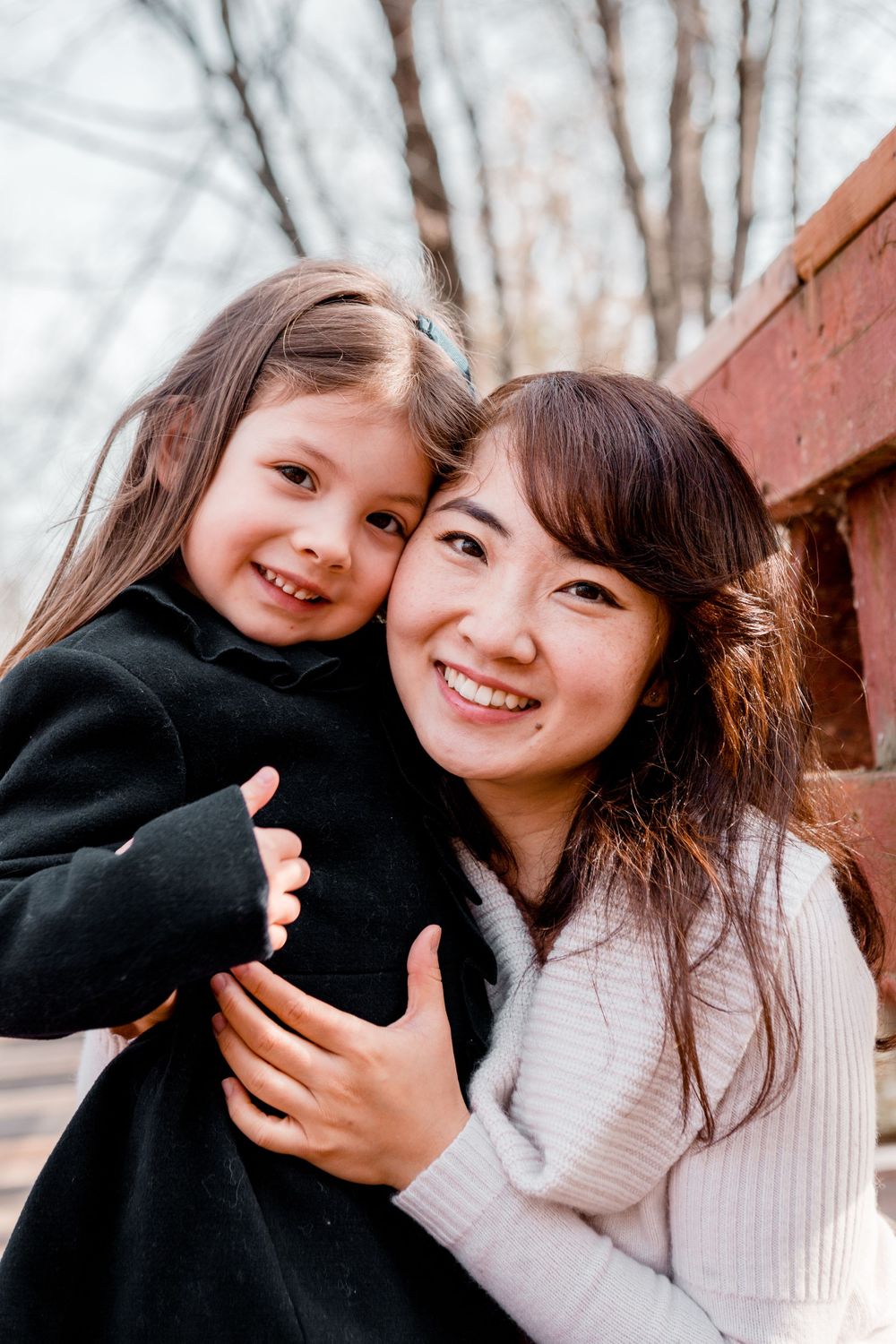 A heartwarming embrace shared between two people against a rustic background.
