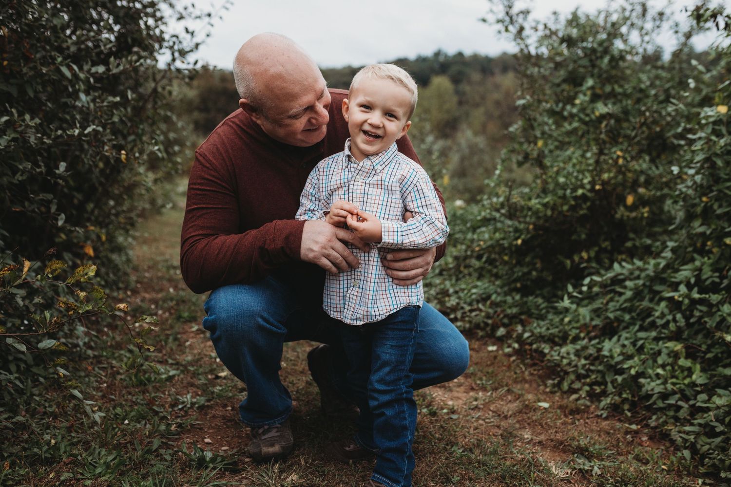 Dad smiles as son laughs for family photo session