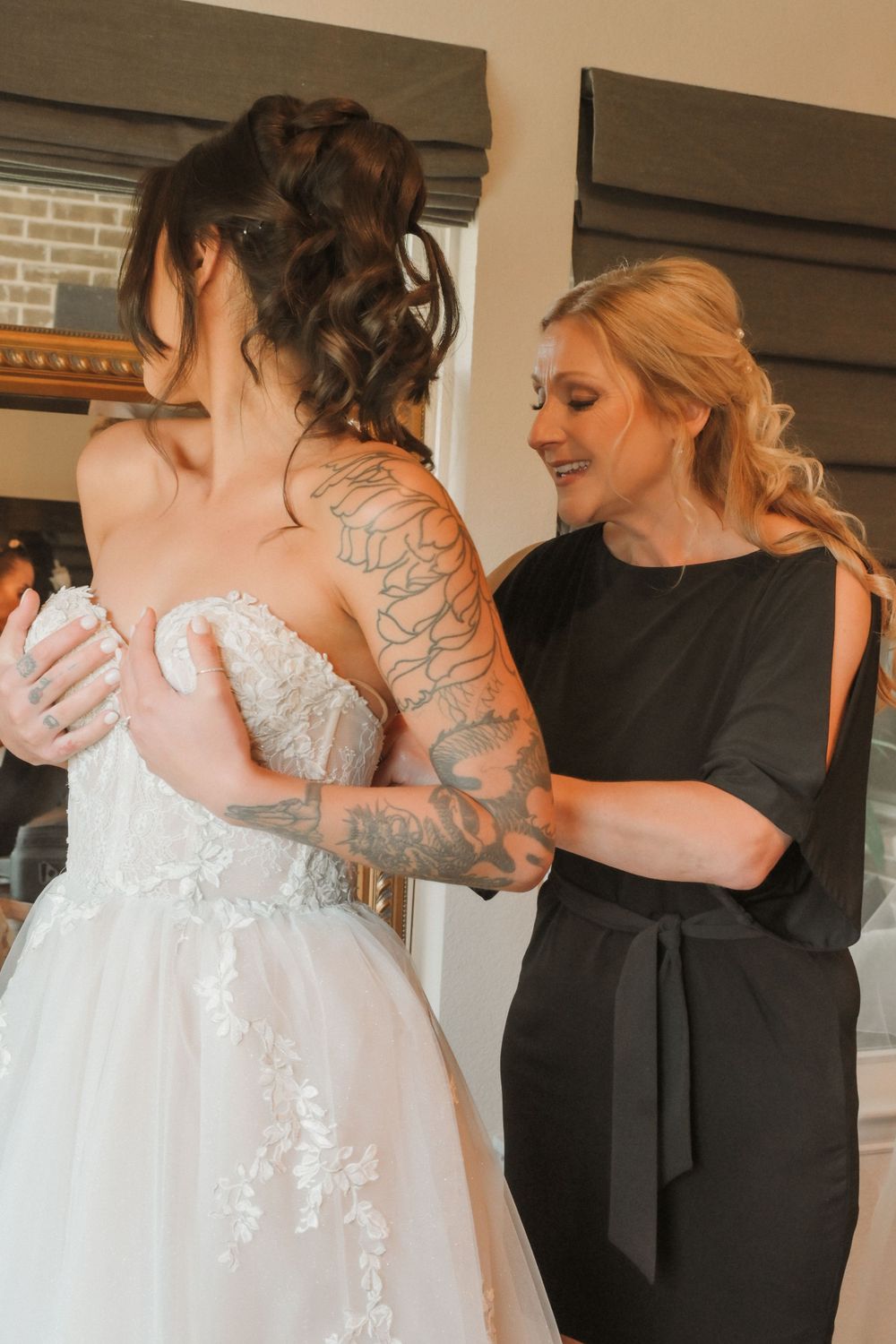 Emotional first look moment captured between couple with bride in white gown and groom in black suit.