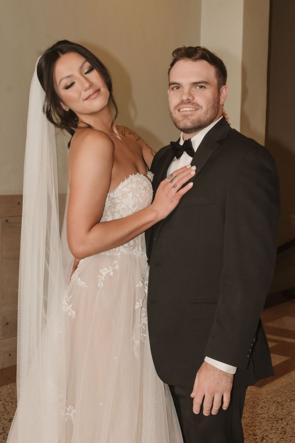 Romantic first look photos of couple sharing tender moments in their wedding attire.