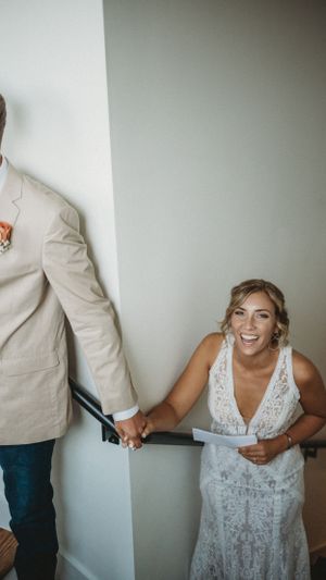 A playful sequence showing a couple in wedding attire sharing a joyful moment against a white wall.