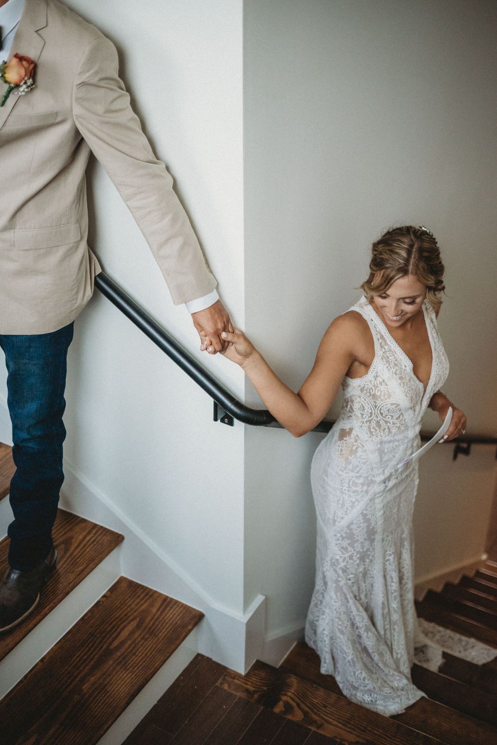 Couple reading private letters to each other on indoor staircase.