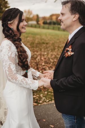 Romantic first look between couple in wedding attire during autumn.
