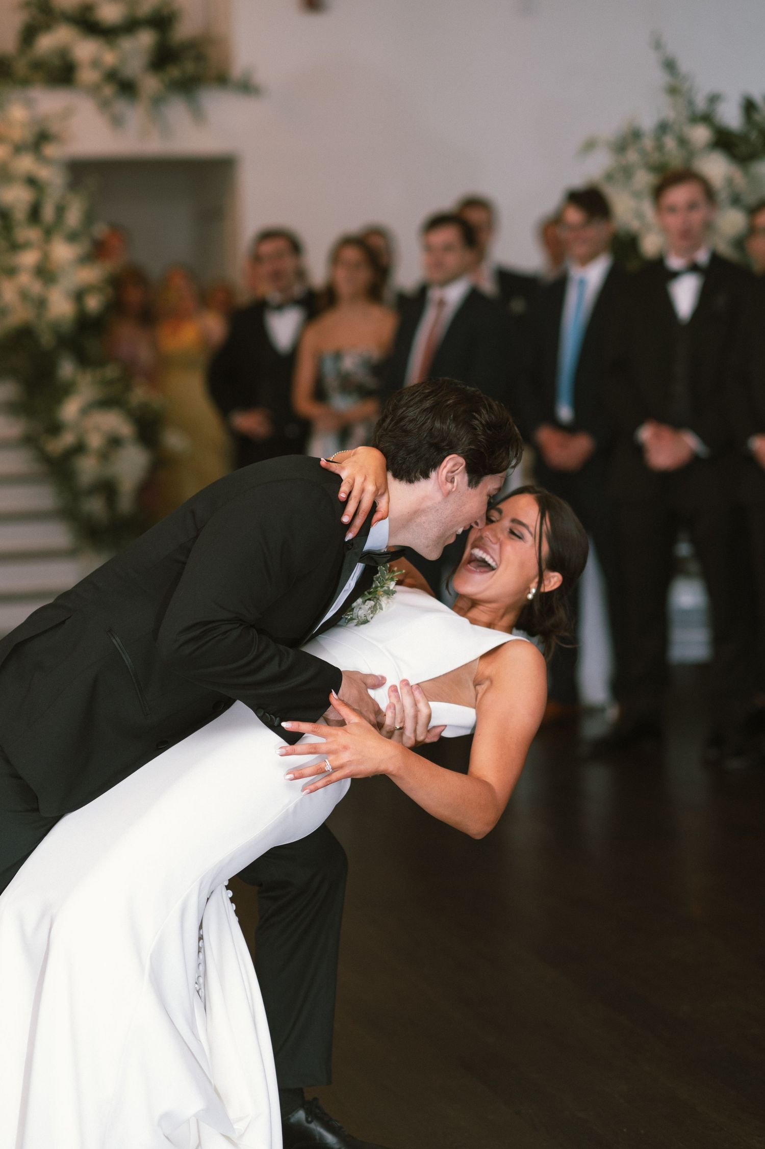 Romantic first dance moment at a wedding reception with elegant decor and lighting.