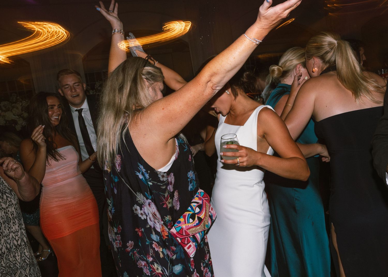 People dancing and having fun at a lively wedding reception party.