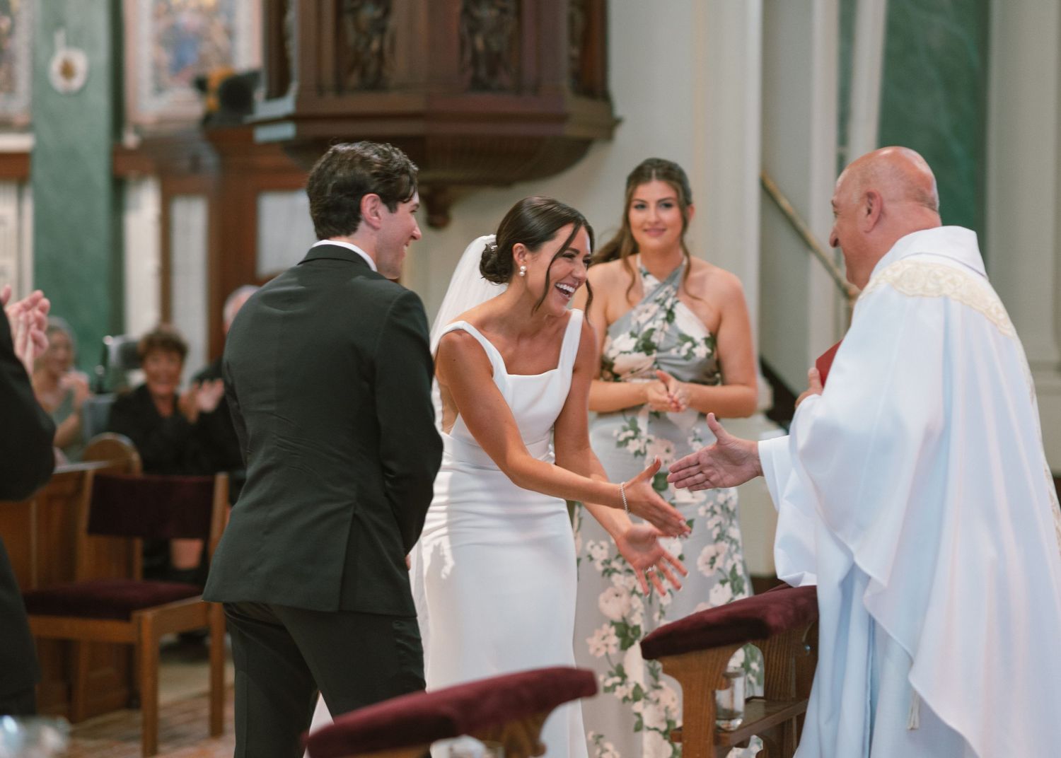Wedding party gathers at the altar during church ceremony.
