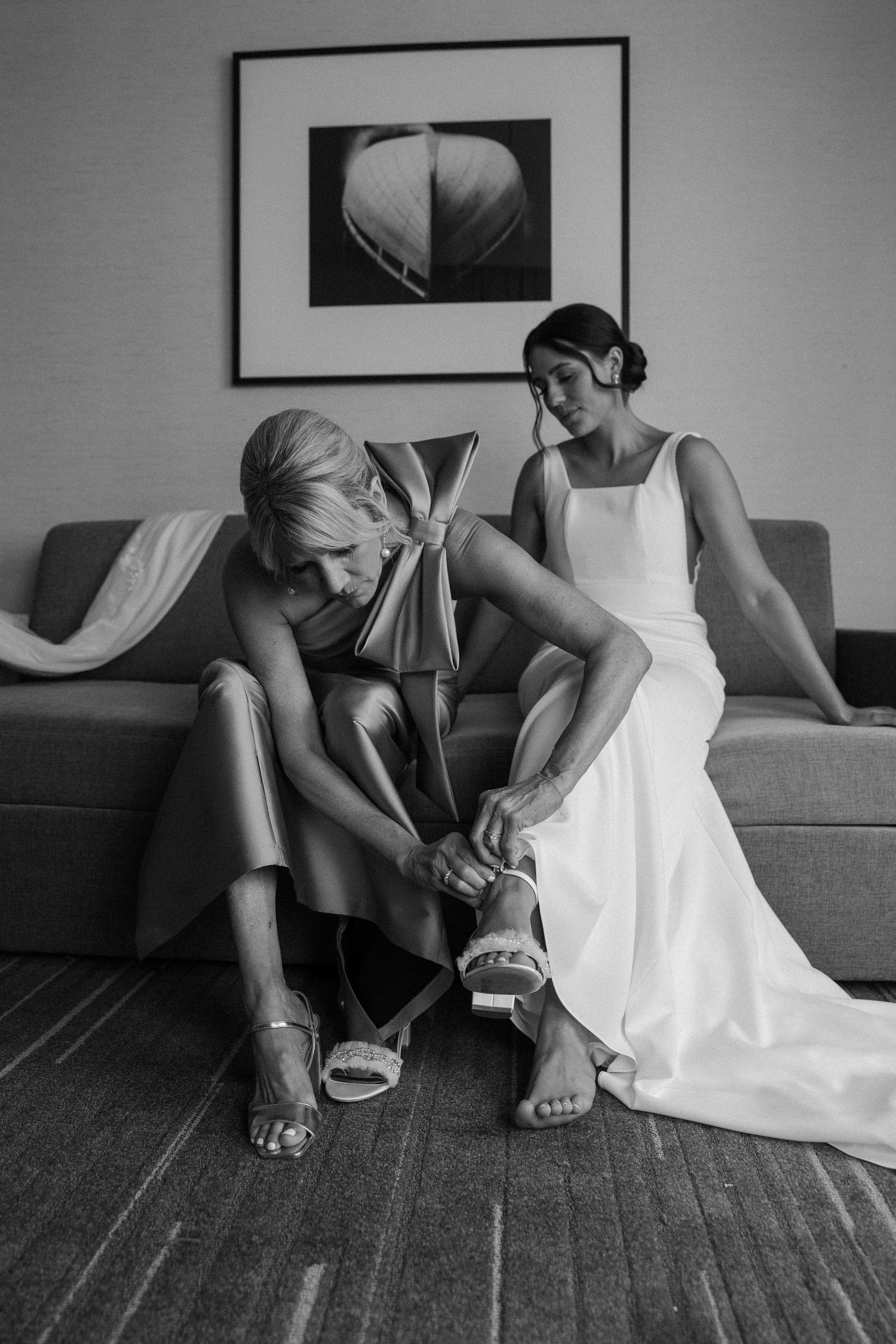 Black and white photos of wedding preparations with focus on dress and shoes.