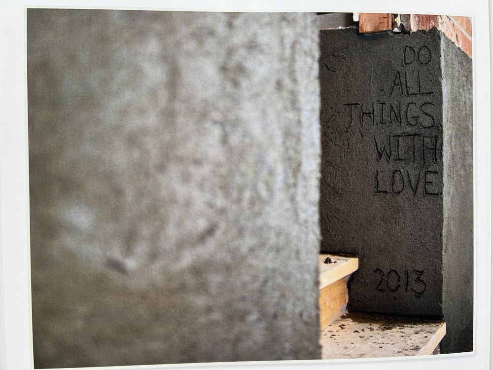 Close-up of concrete wall texture with faint writing visible.