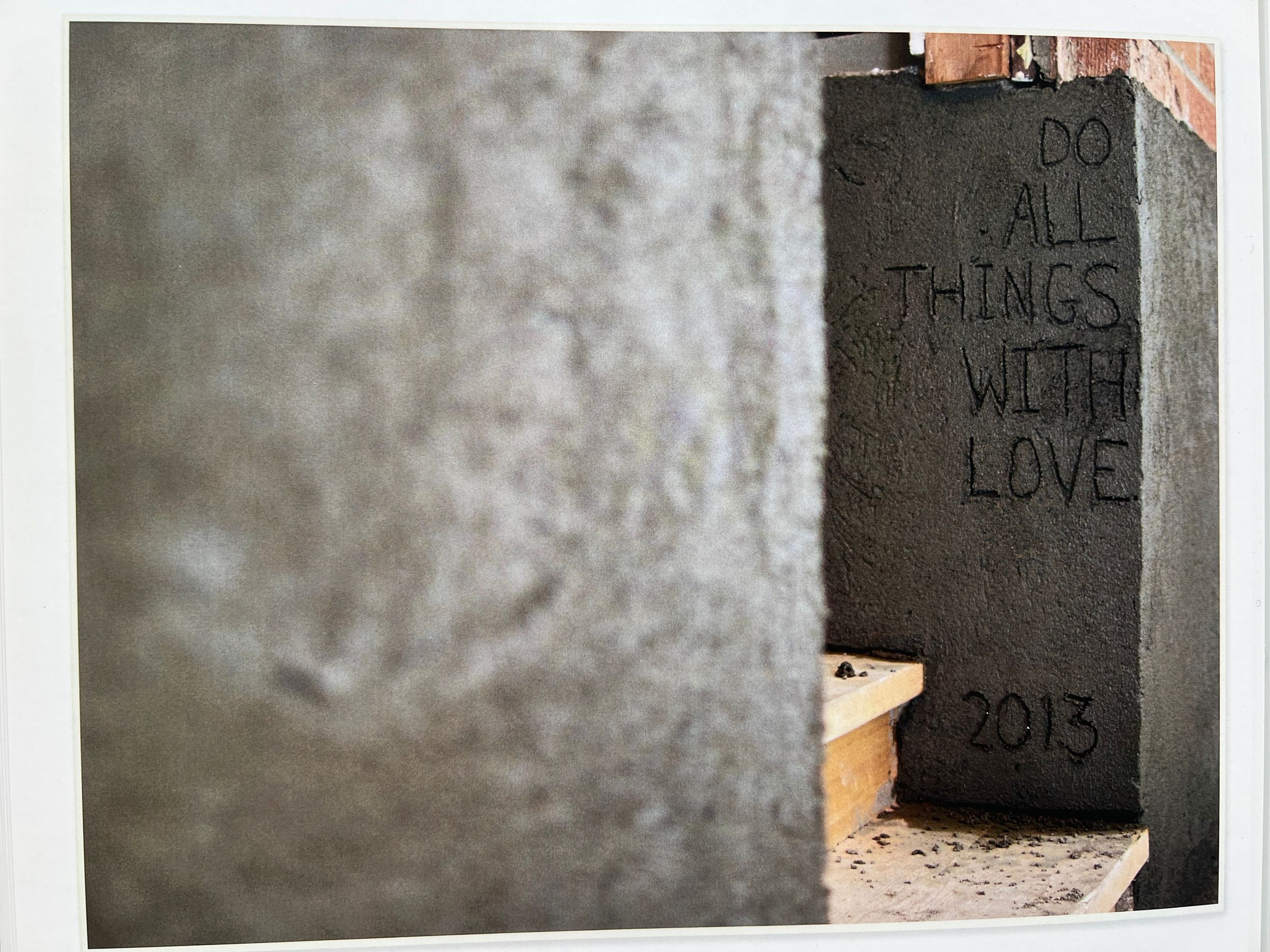 Close-up of concrete wall texture with faint writing visible.