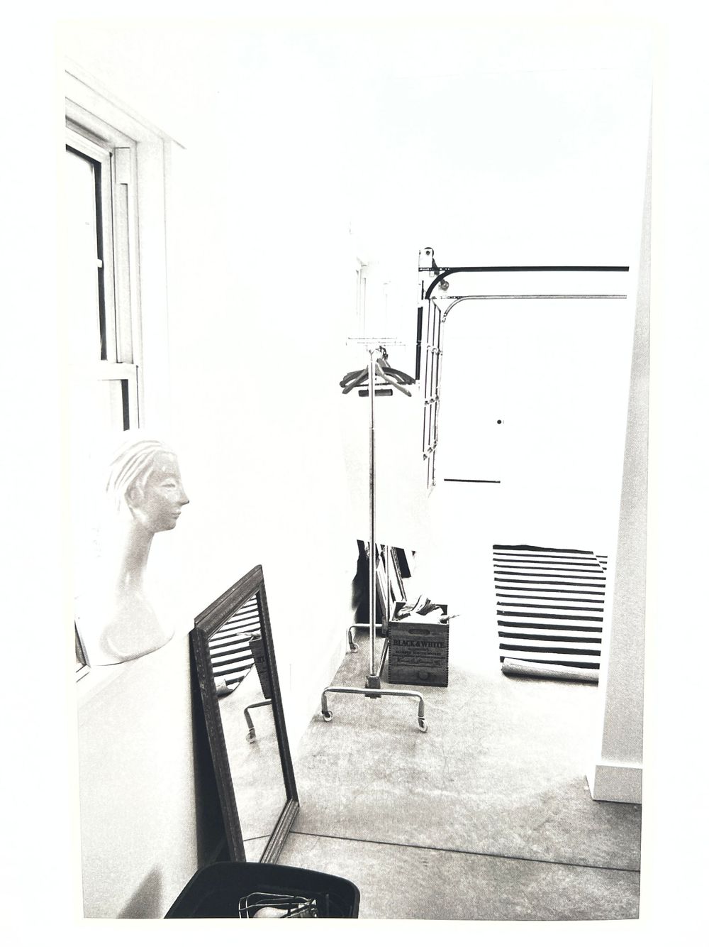 Empty white room with windows and blinds during renovation process.