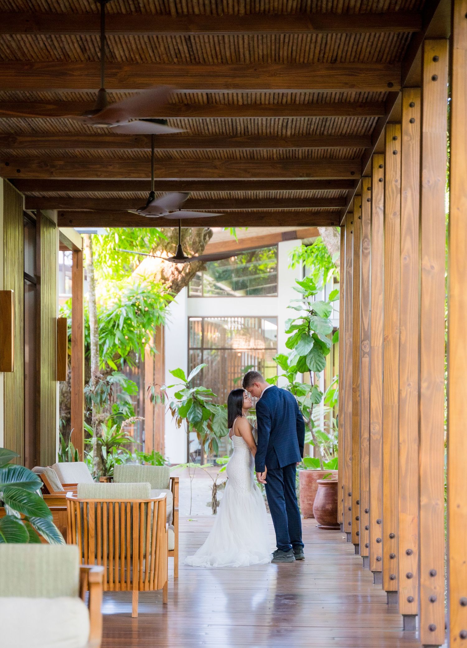 Bride and groom holding hands at the end of the aisle in Botanika Osa Peninsula, Curio Collection by Hilton.