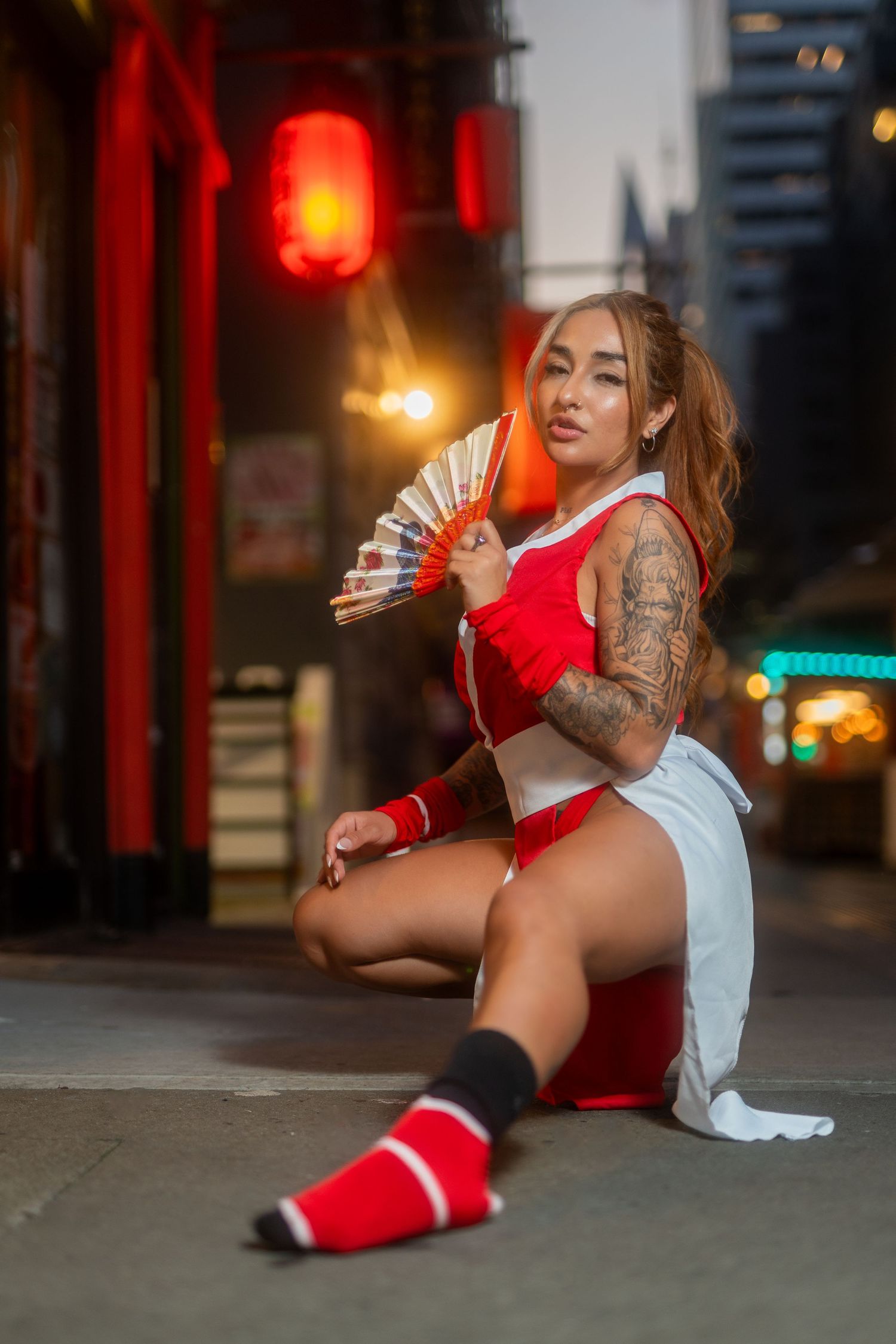 Street photography with Asian-inspired styling featuring red and white outfit against urban backdrop.