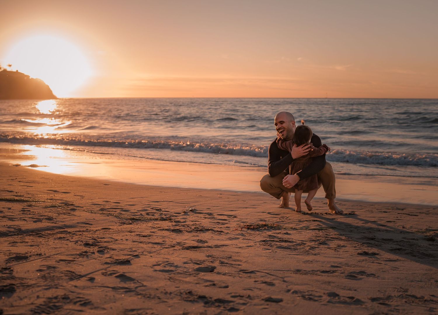 Couple enjoying romantic moment on beach at sunset.