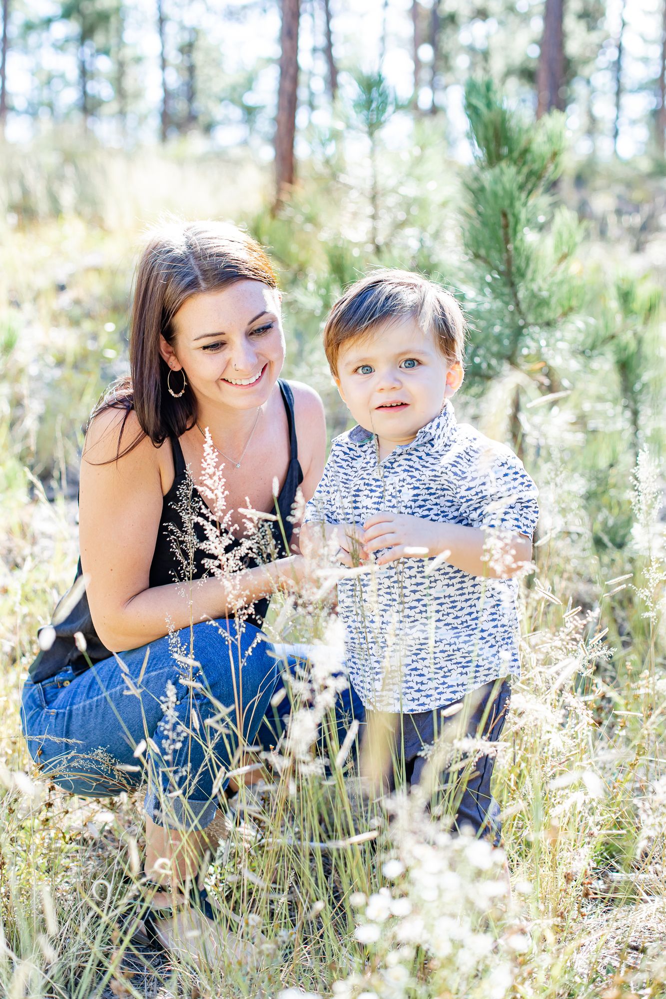 Mom and her toddler son look at nature together in Black Forest, Colorado.