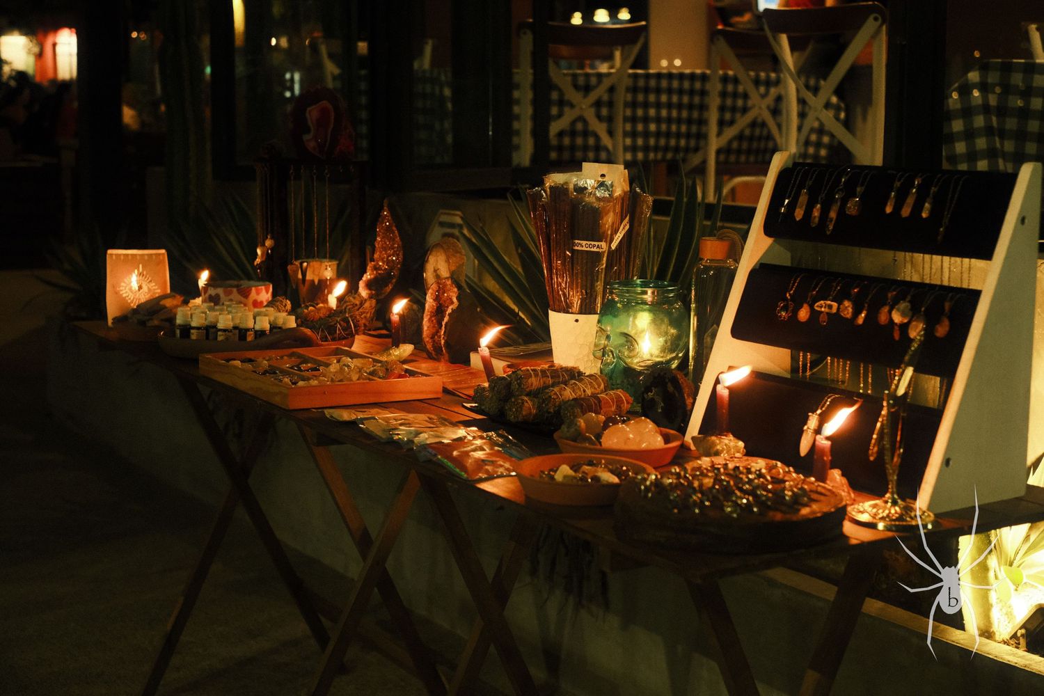 Halloween-themed table display with pumpkins and candles creating spooky ambiance.