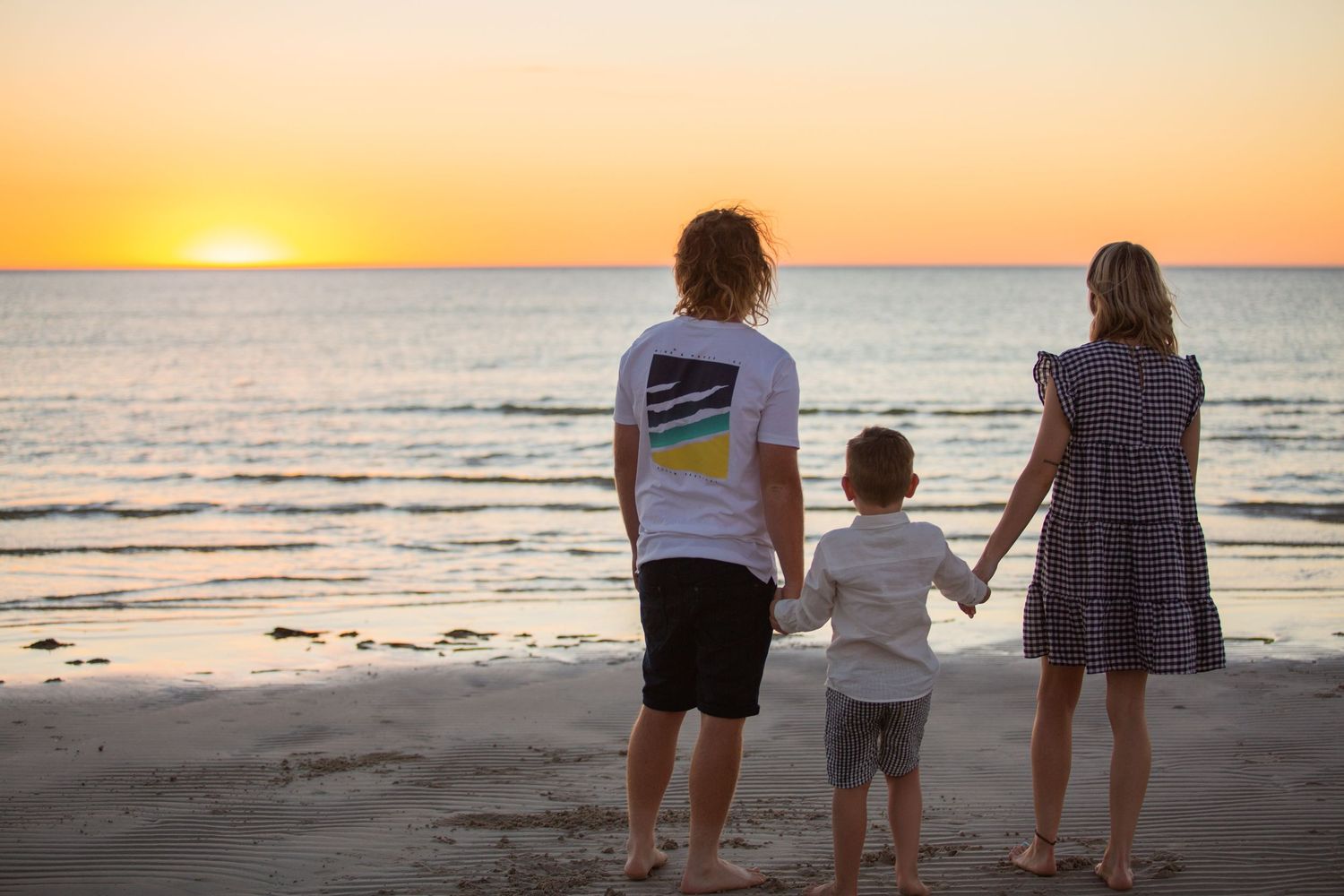 Eran and Keenan with their son facing the water in kemp place at Moonta Bay