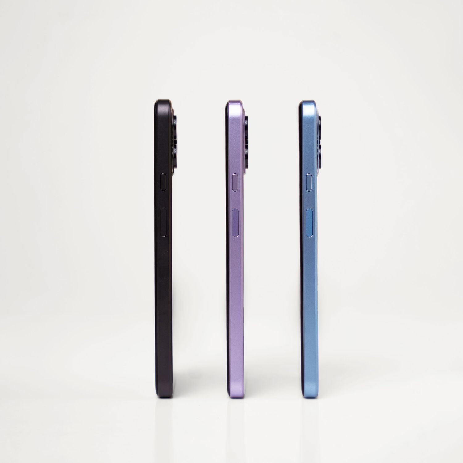 Three smartphones in black, purple, and blue colors shown side by side against white background.