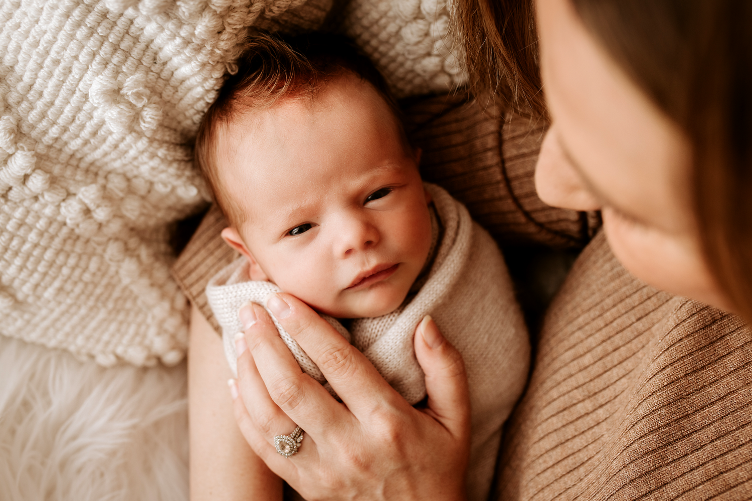 Series of intimate newborn portraits showing gentle parent interactions.