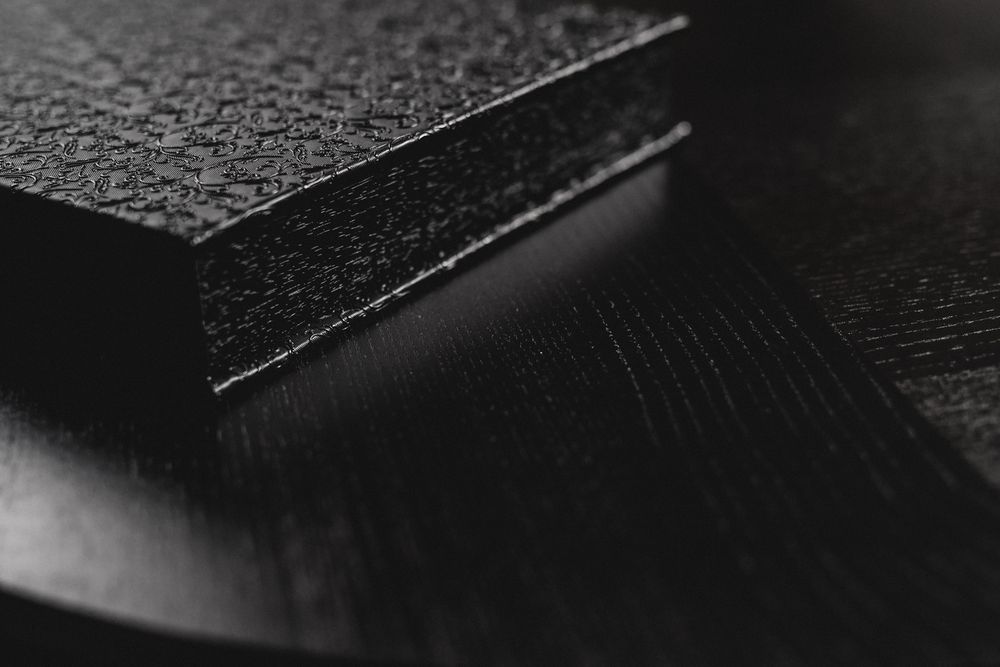 Close-up macro shot of a textured black surface with embossed patterns.
