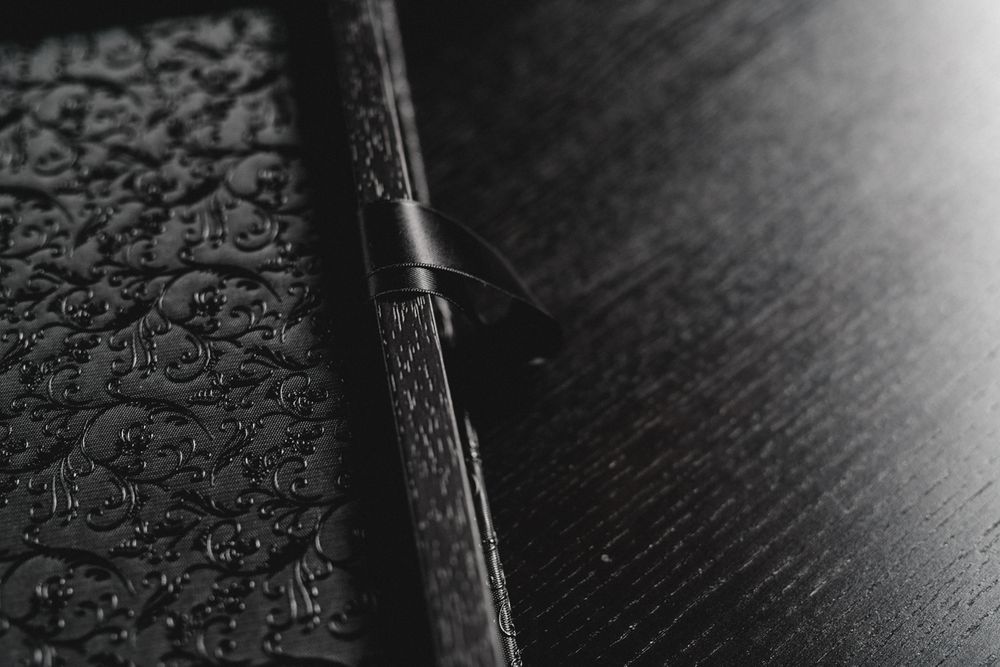 Detail shot of a black leather book binding with textured surface.