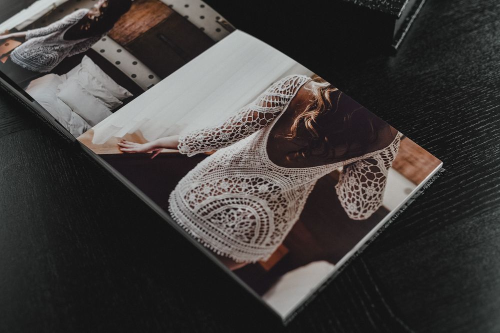 A wedding photo album page showing delicate lace details in warm tones.
