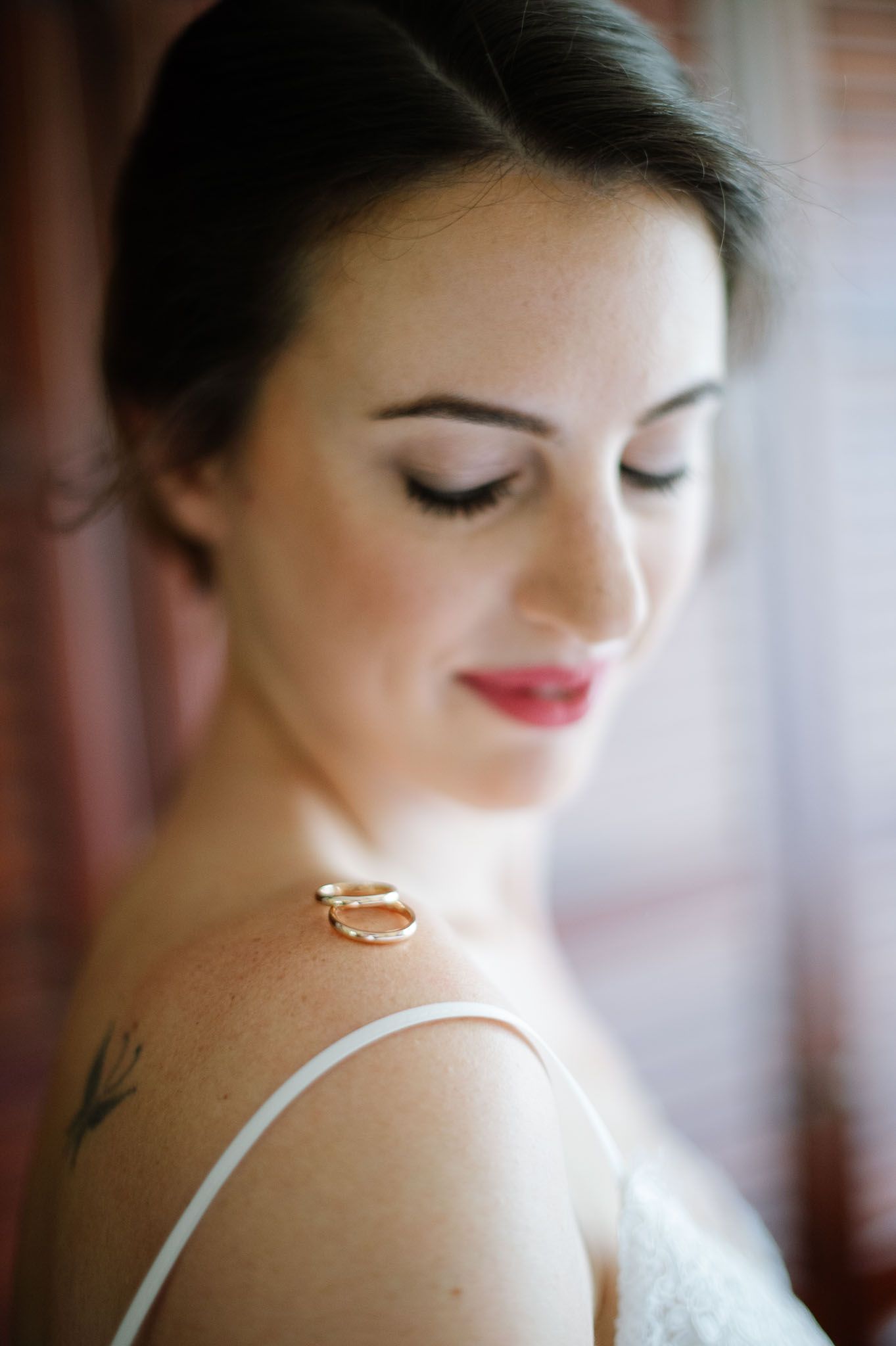 Elegant close-up portrait of bride with soft makeup and delicate jewelry.
