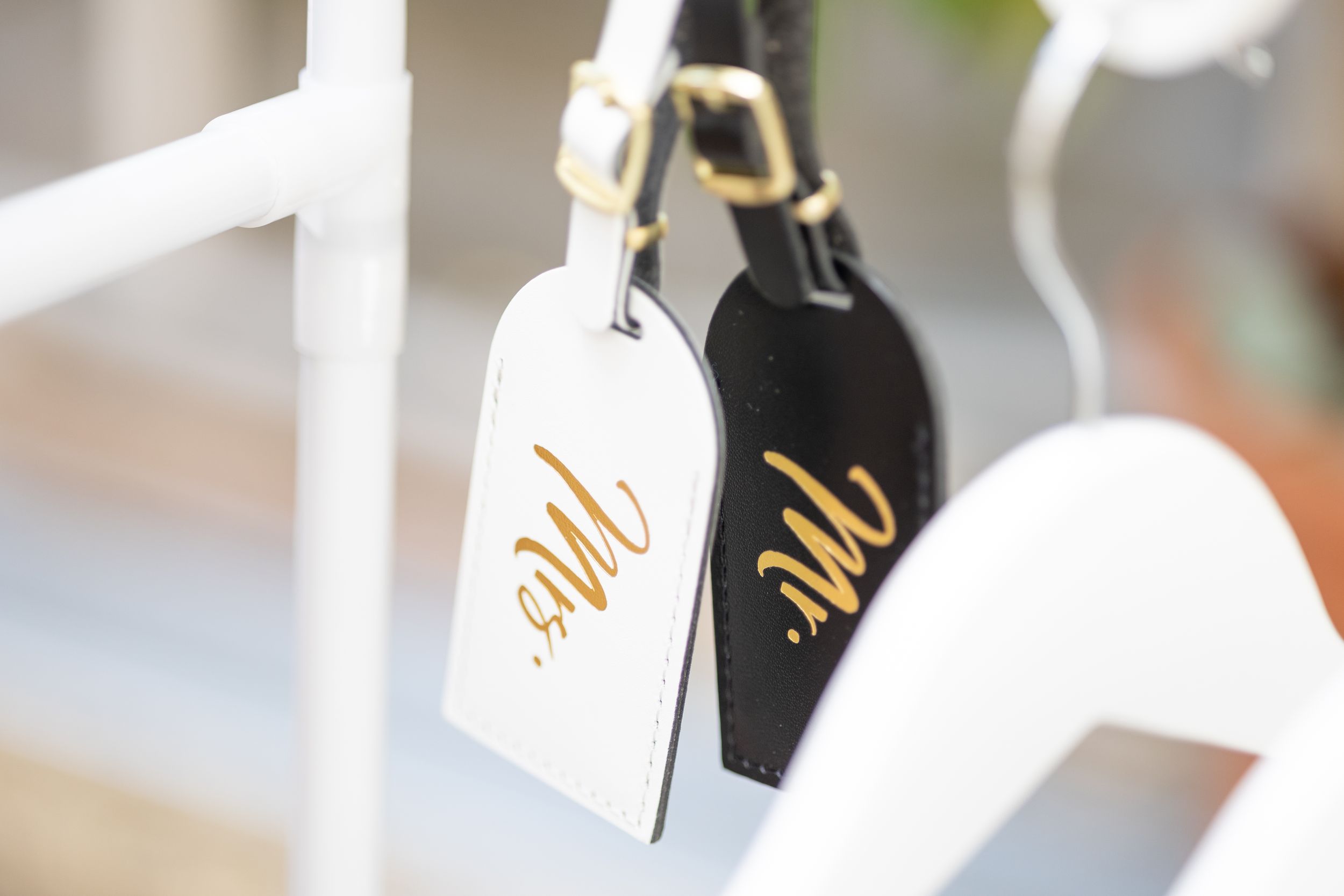 Black and white Mr and Mrs tags hanging against white background.