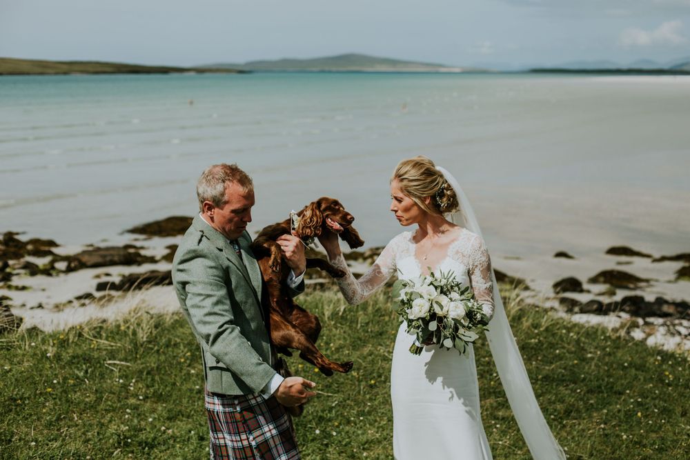 A wedding couple with their dog enjoying moments by the Scottish seaside.