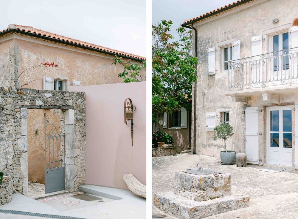 Traditional stone buildings with pastel pink walls and white trim in Mediterranean architectural style.