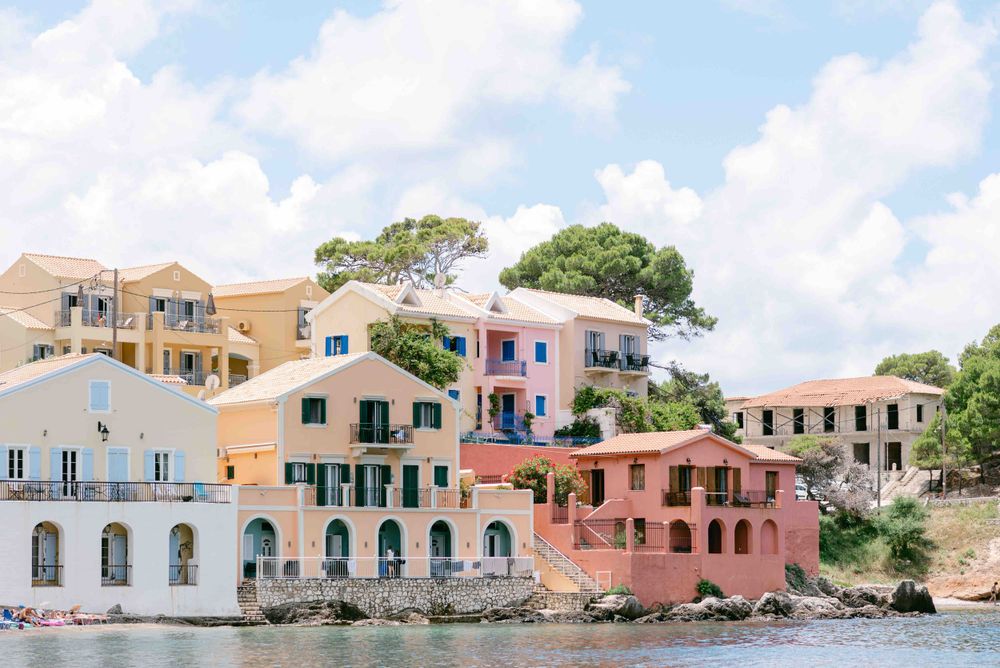 Colorful coastal houses along the waterfront in Mediterranean style architecture.