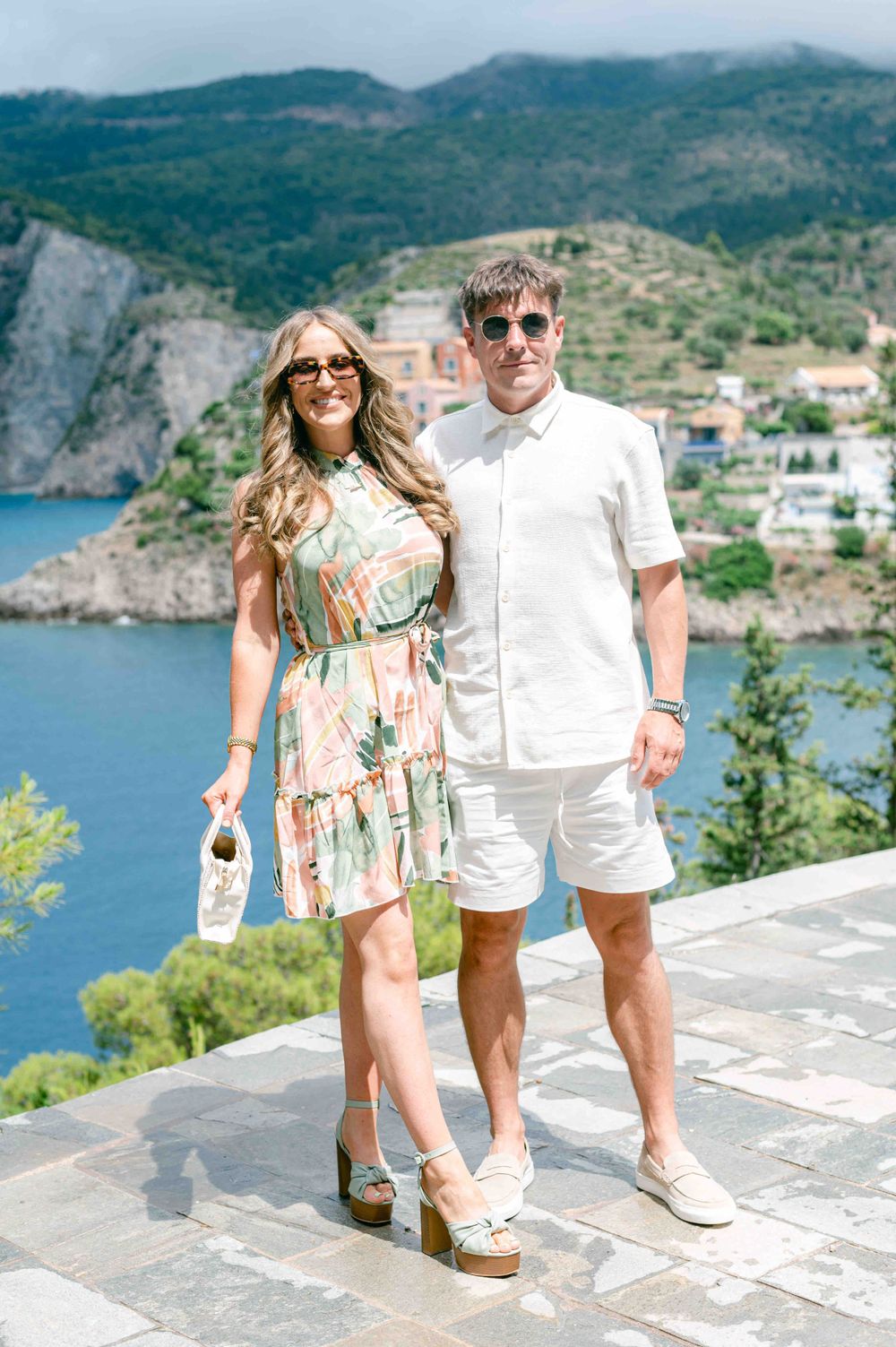 Stylish summer outfits against a beautiful Mediterranean coastal backdrop.