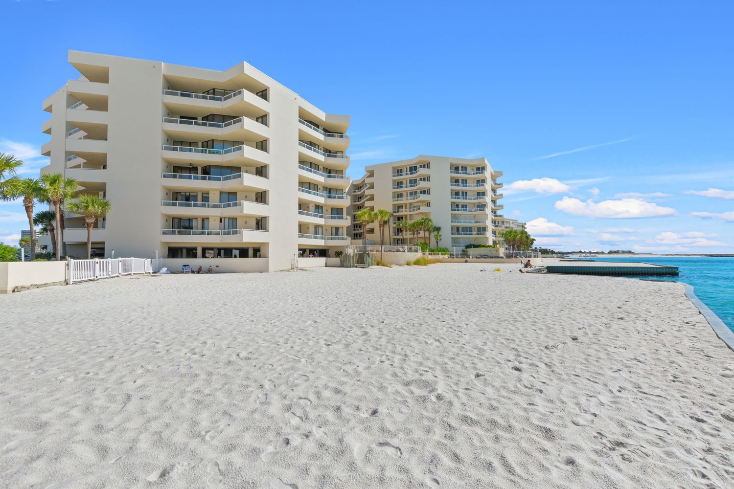 Beachfront condominium buildings with private beach access and ocean views.