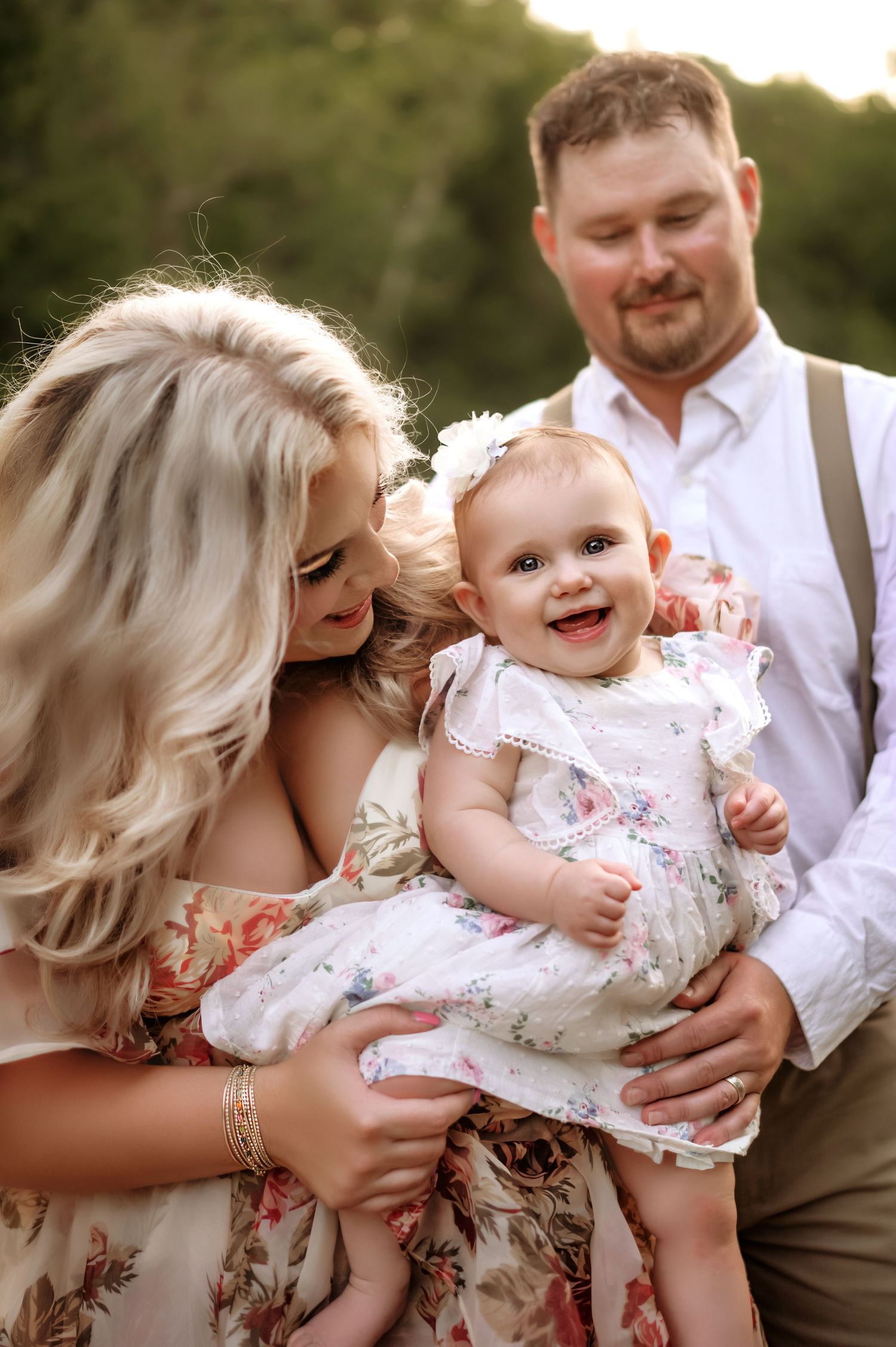 Happy family shares joyful moment outdoors during golden hour.