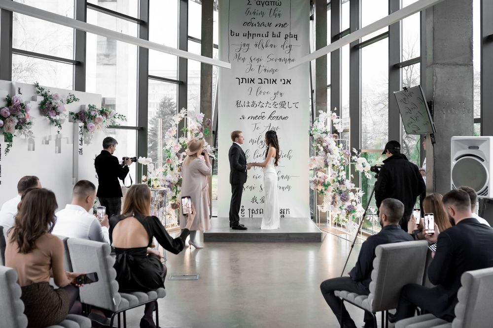 Modern wedding venue with text-covered walls and elegant decor.