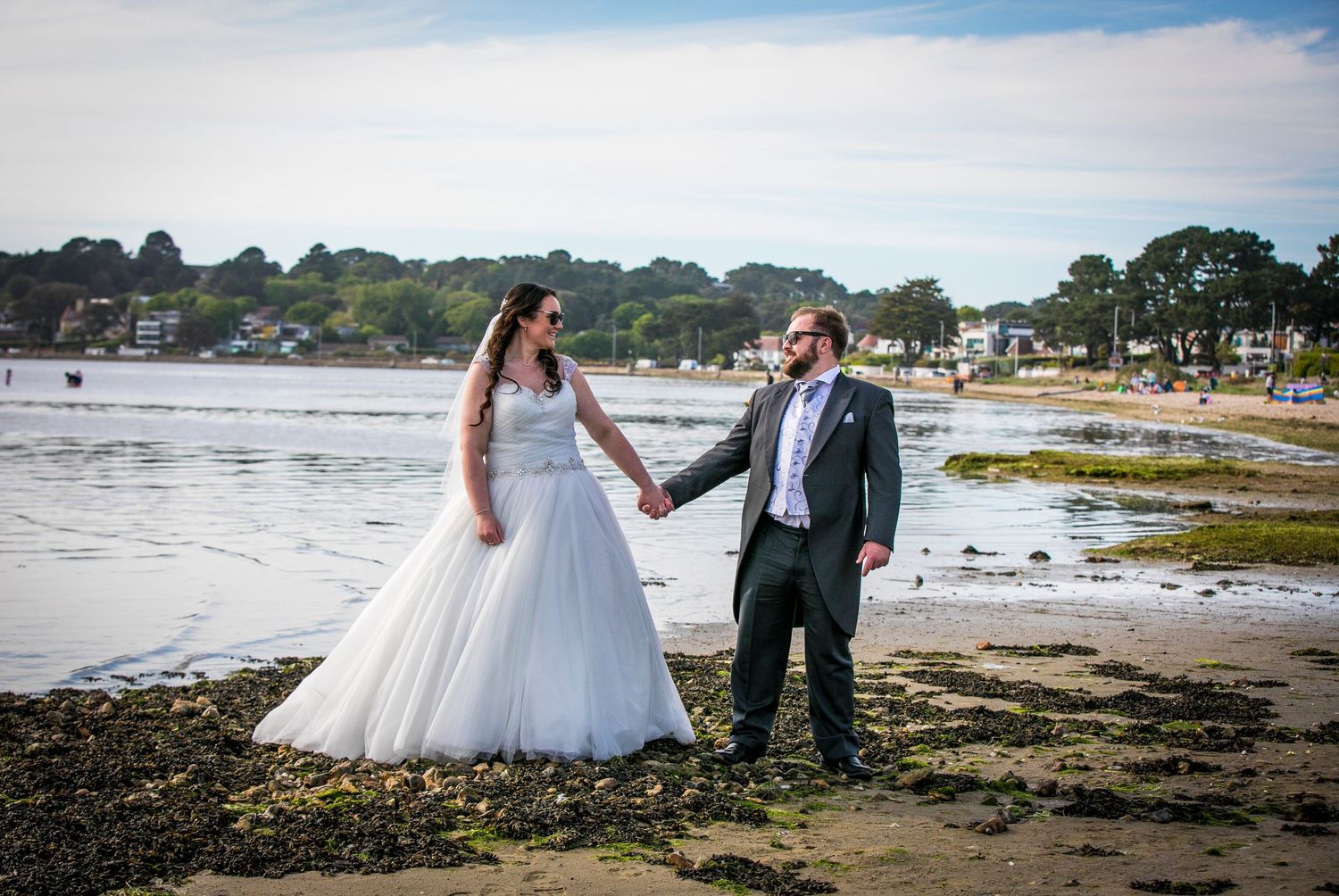 Romantic beach wedding photography sequence with couple walking along the shoreline.
